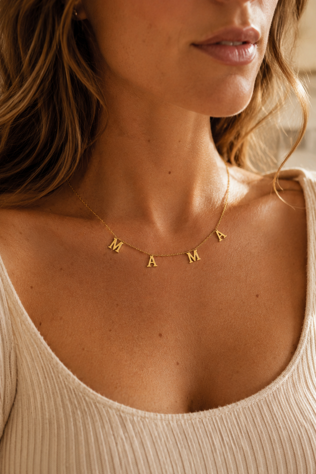 Woman wearing the Mamacita Collective 18k gold-plated MAMA necklace.