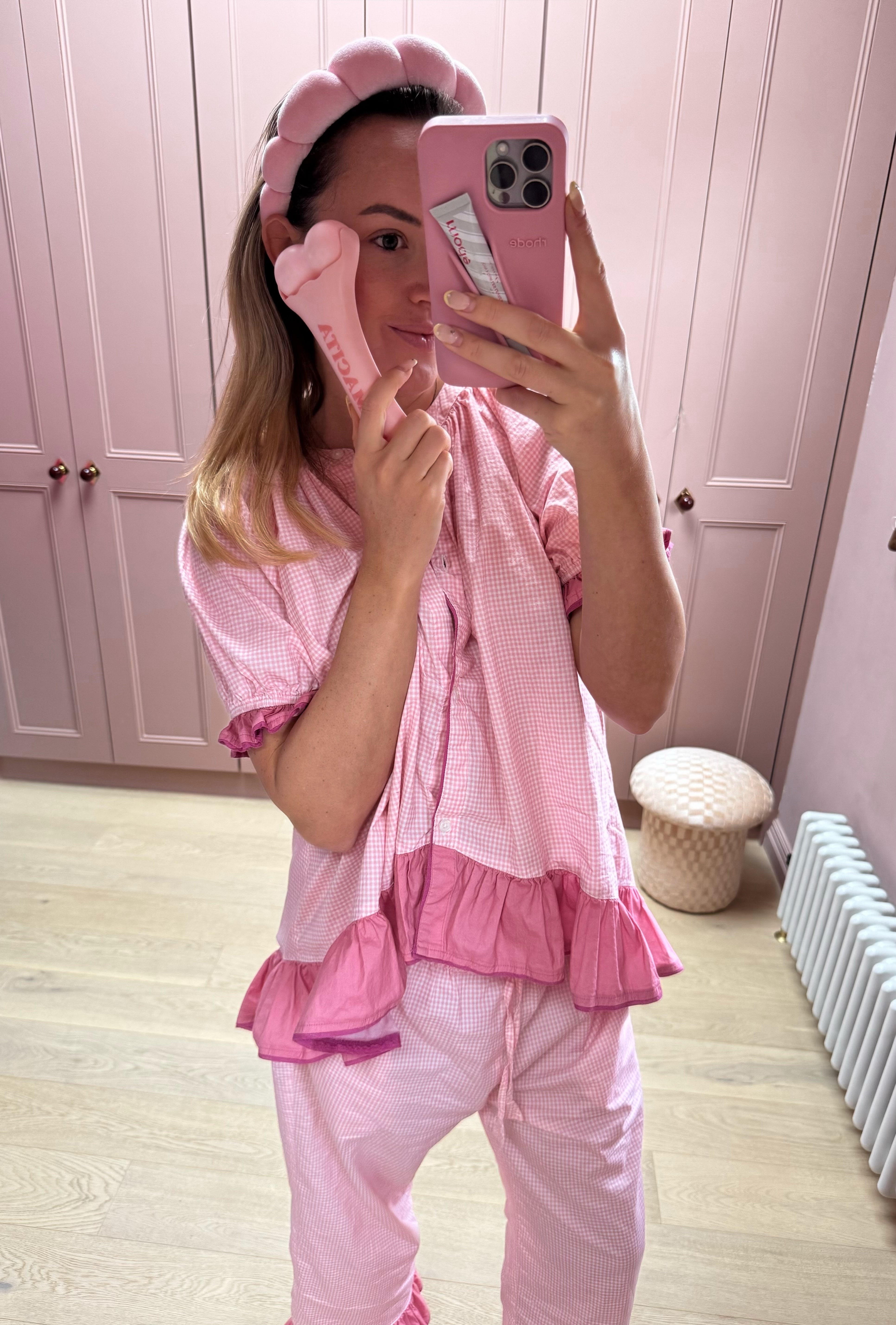 A woman using the Hot Mama Ice Roller on her face as part of a skincare routine.