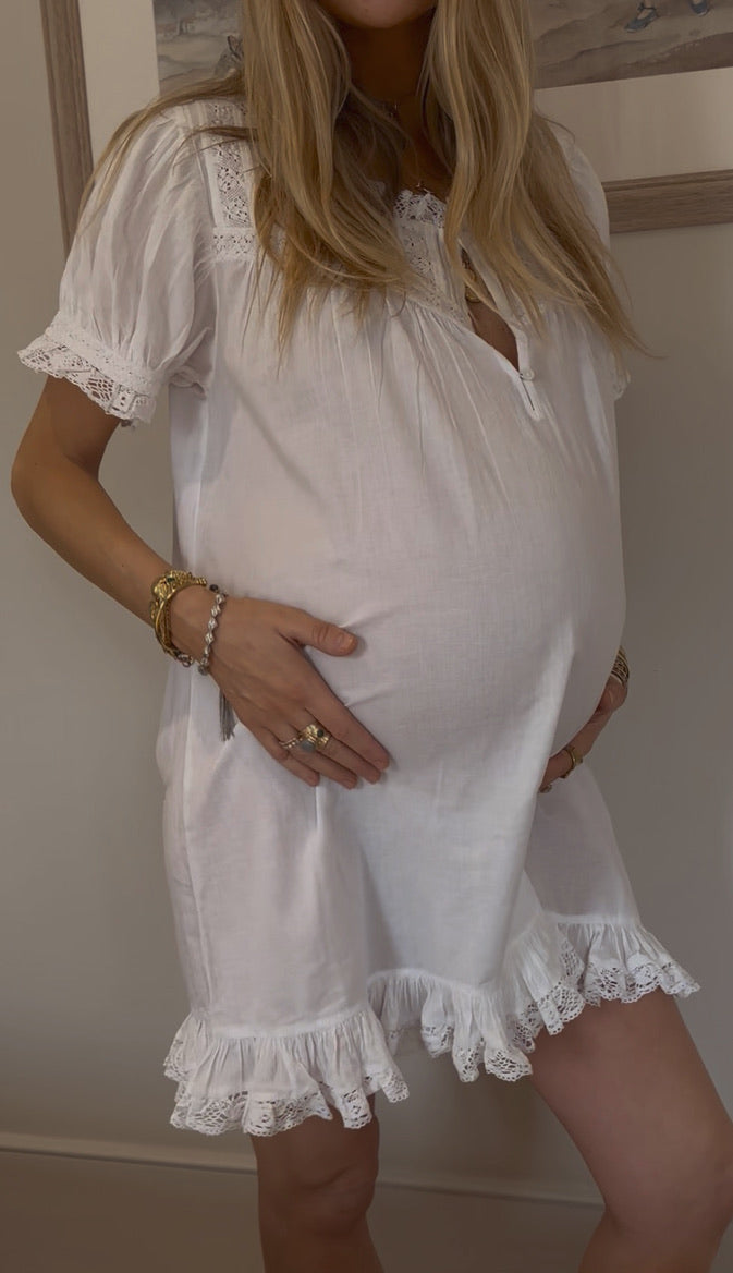 Gigi lace nightdress showing its gathered fit and lace hem.