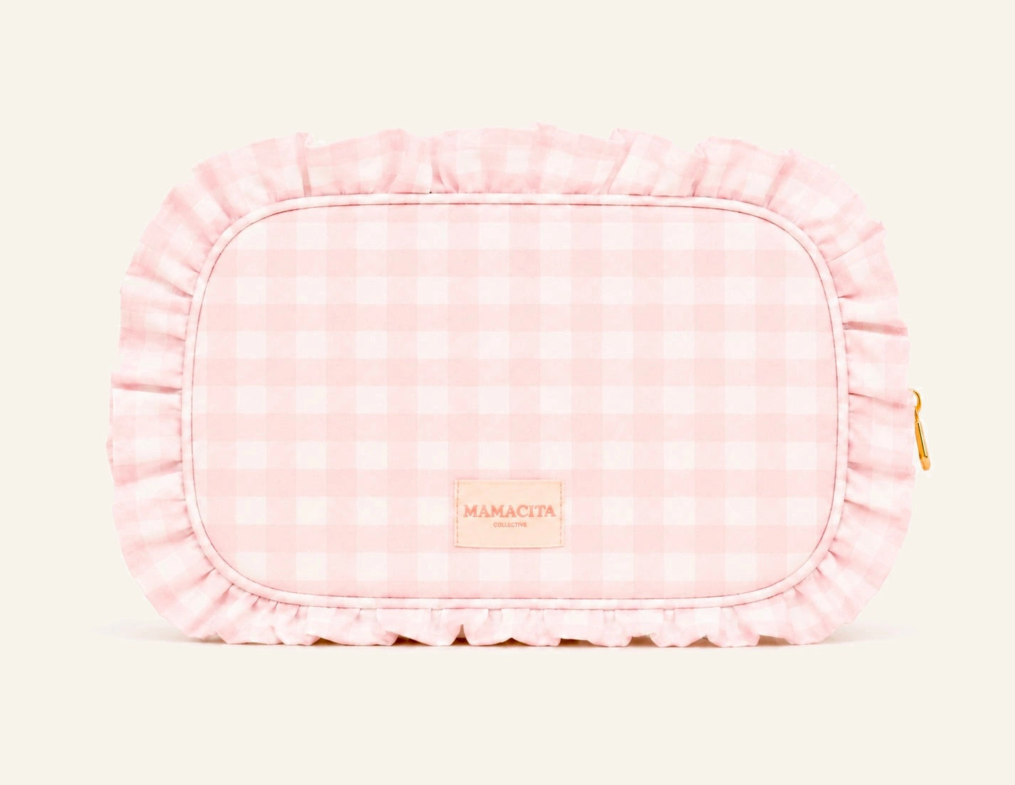 A pink and white gingham check cosmetic pouch with a ruffled edge, featuring a small tan leather patch with the brand name 'MAMACITA PARIS' and a gold zipper pull on the right side.