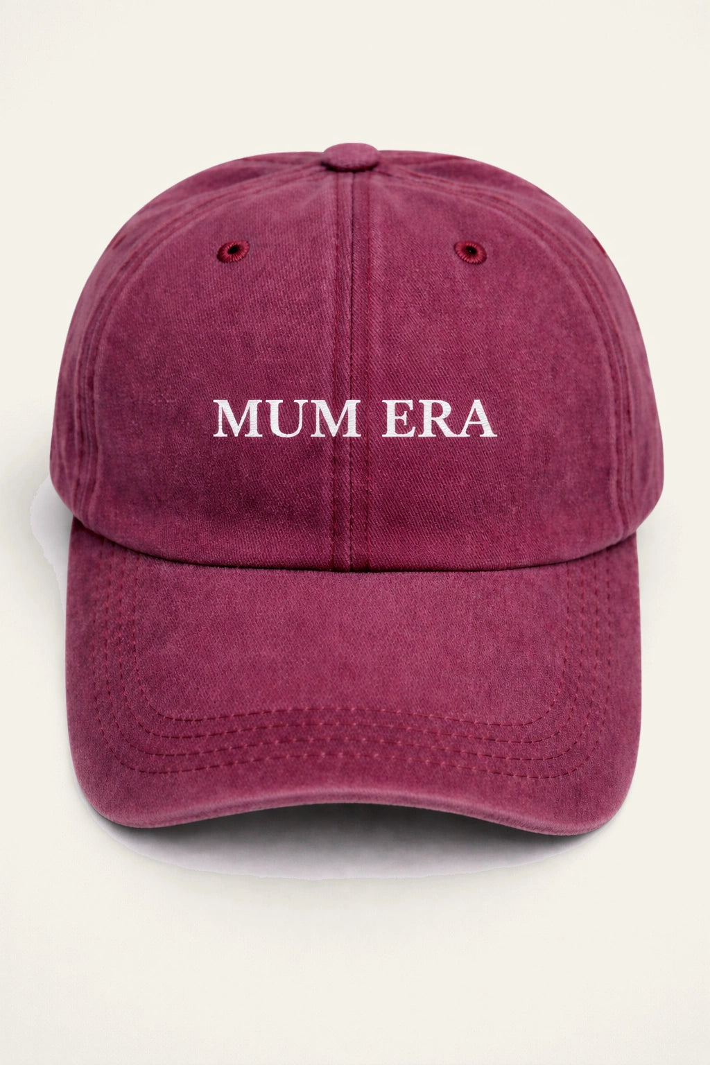 The Mum Era Cap in burgundy with white embroidered 'MUM ERA.' slogan.
