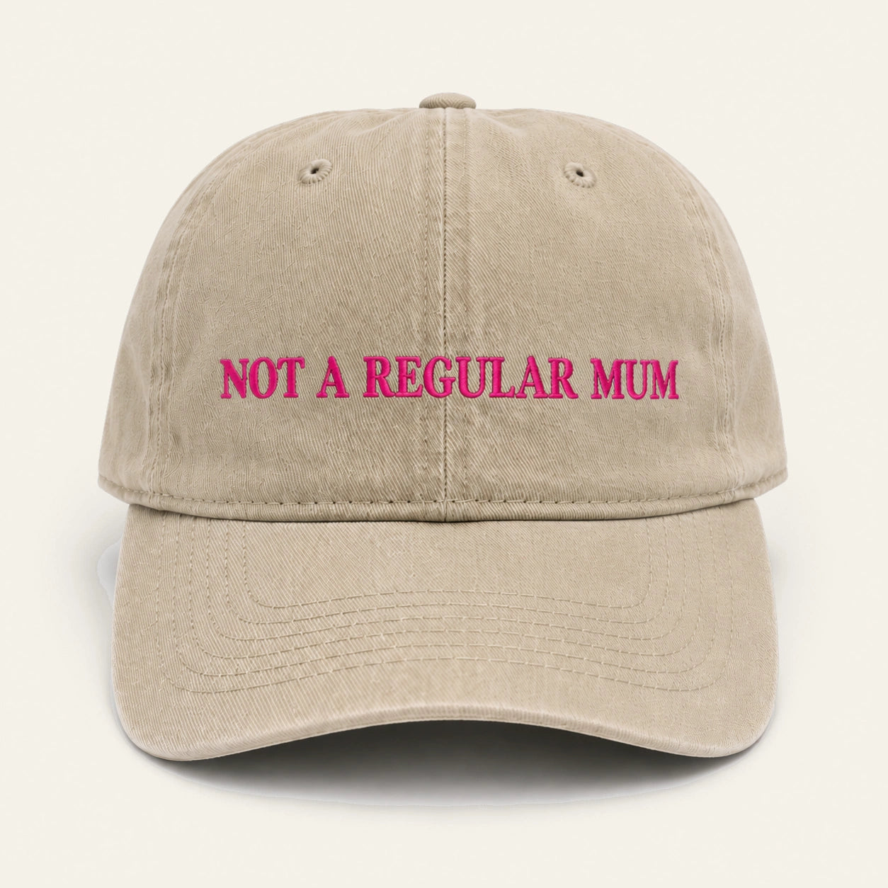 The Not a Regular Mum Cap in beige, worn outdoors.
