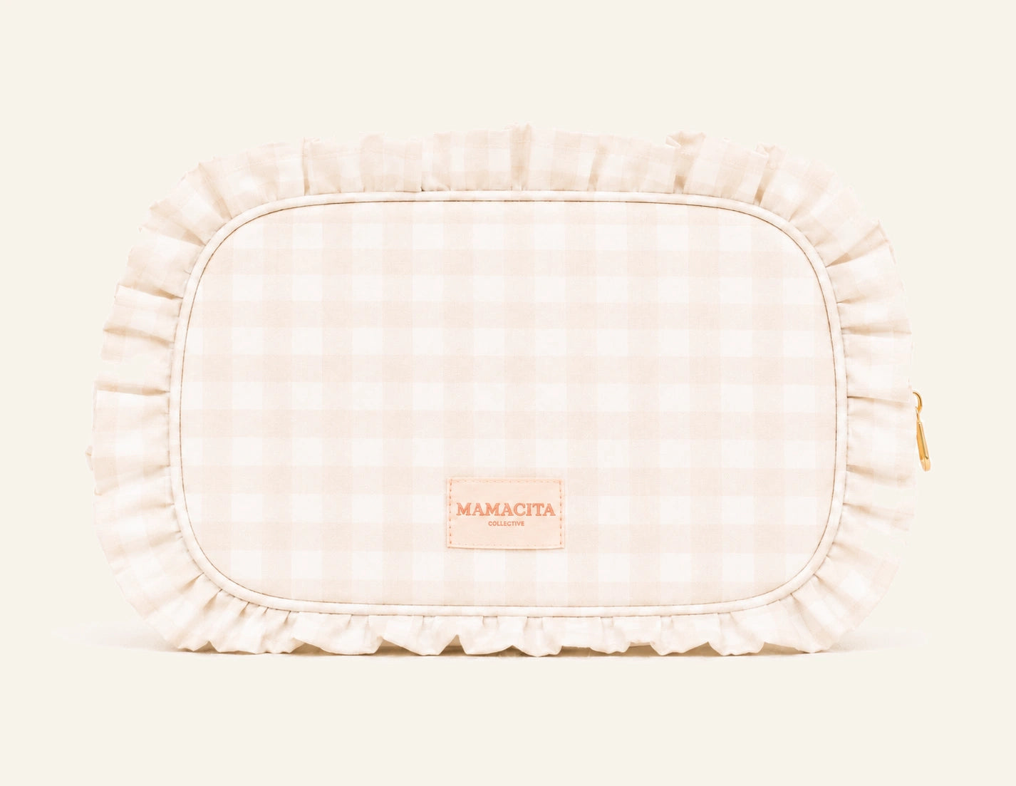 A light beige and white gingham toiletry bag with a ruffled fabric border and a small tan brand patch reading 'MAMACITA' on the front, photographed on a clean white background.