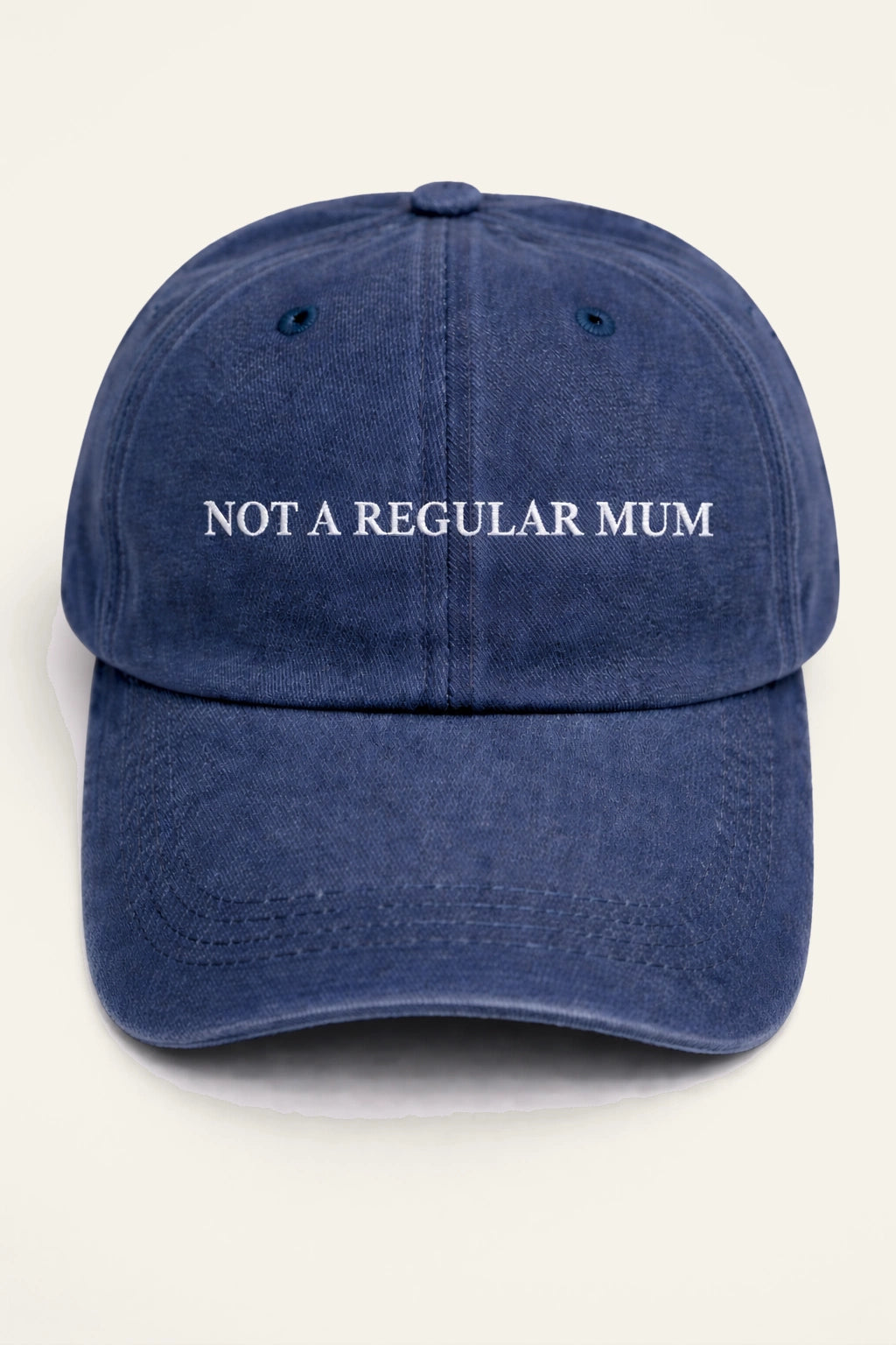 Close-up of the Not a Regular Mum Cap's embroidered slogan detail.