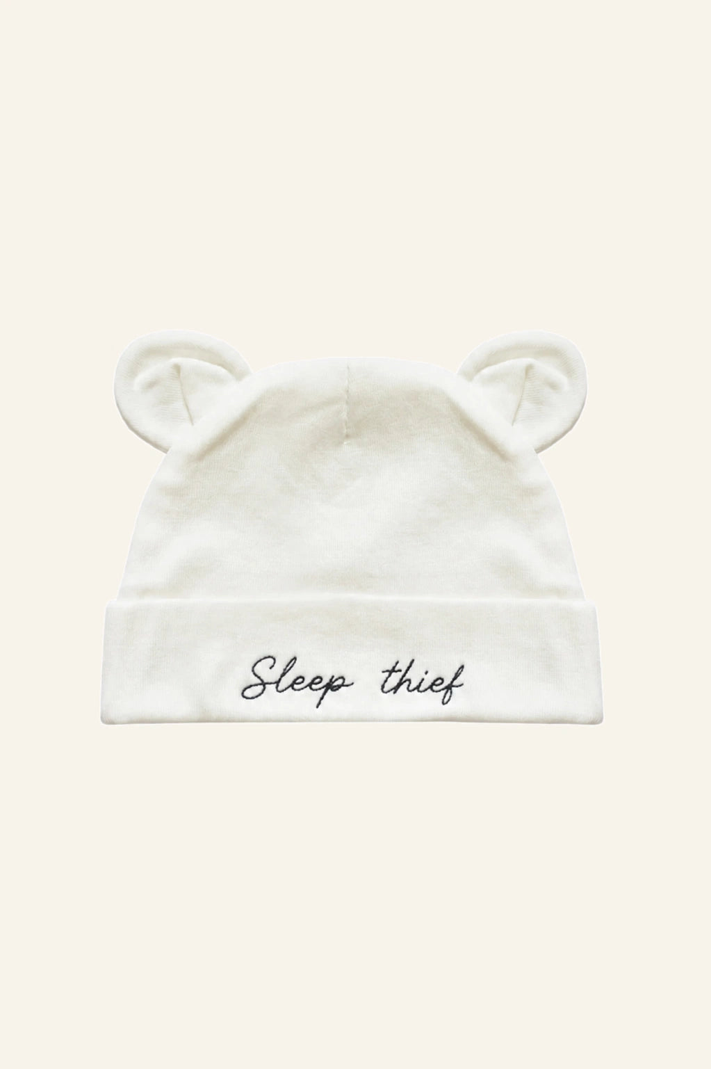 Mamacita Collective Soft Newborn Hat in White worn by a baby.