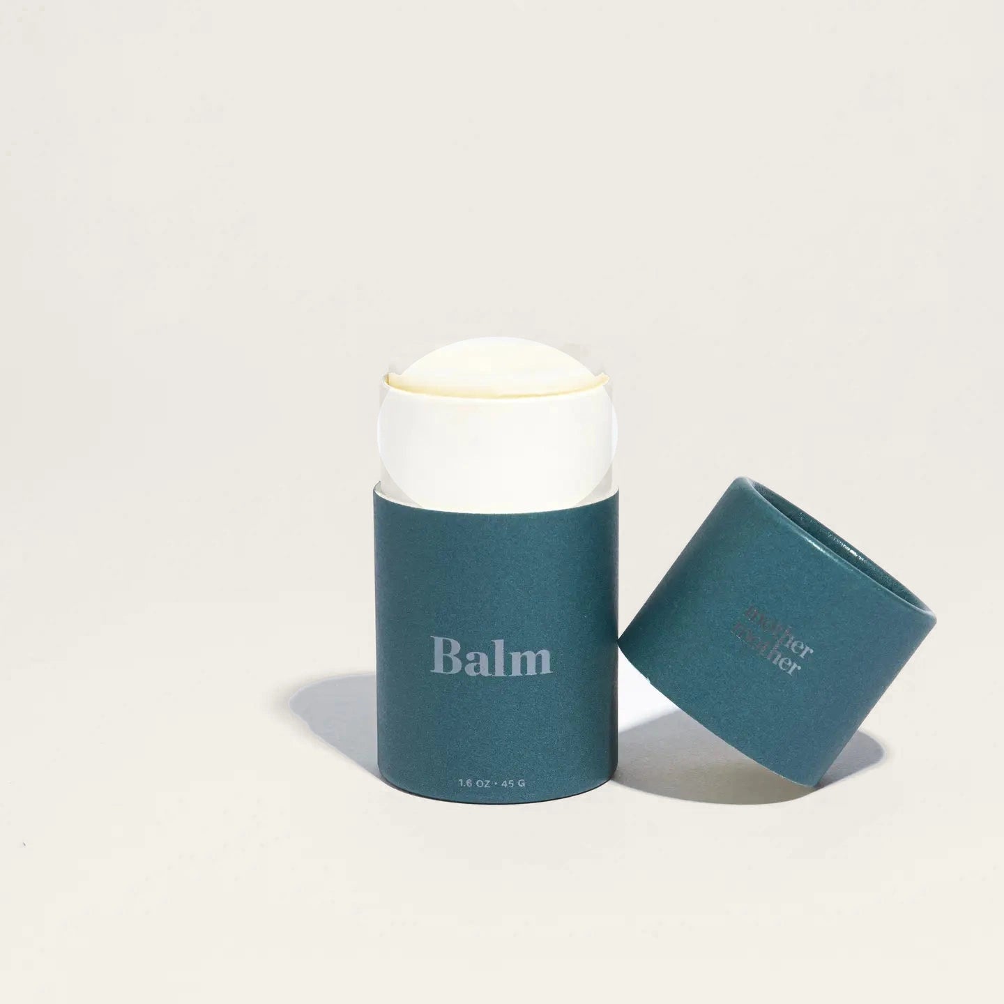Mother Mother Belly + Body Balm in its sustainable paper tube, shown against a plain background.
